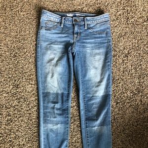 Blue jeans with dark knee patches